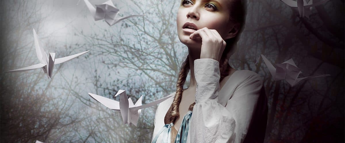 image of woman surrounded by origami birds