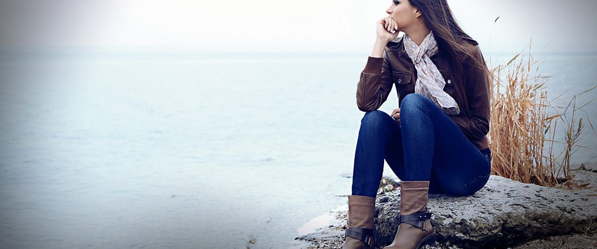 image of unhappy woman sitting by the shore