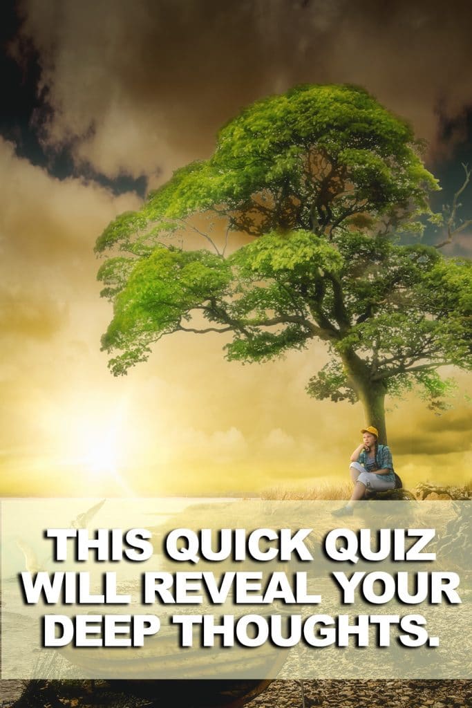 image of woman sitting alone near a river bank with boat